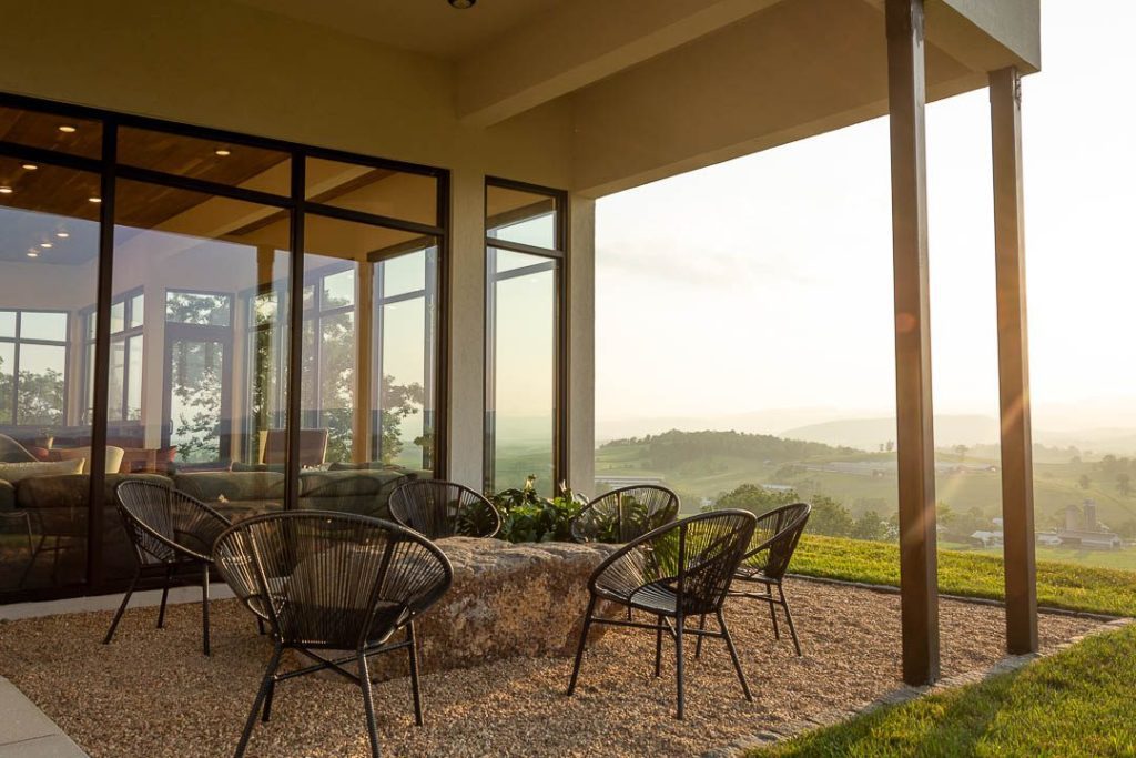 outdoor seating area, light beams coming from setting sun over mountains